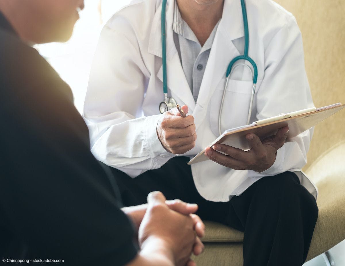 back of a patient who is facing a doctor 