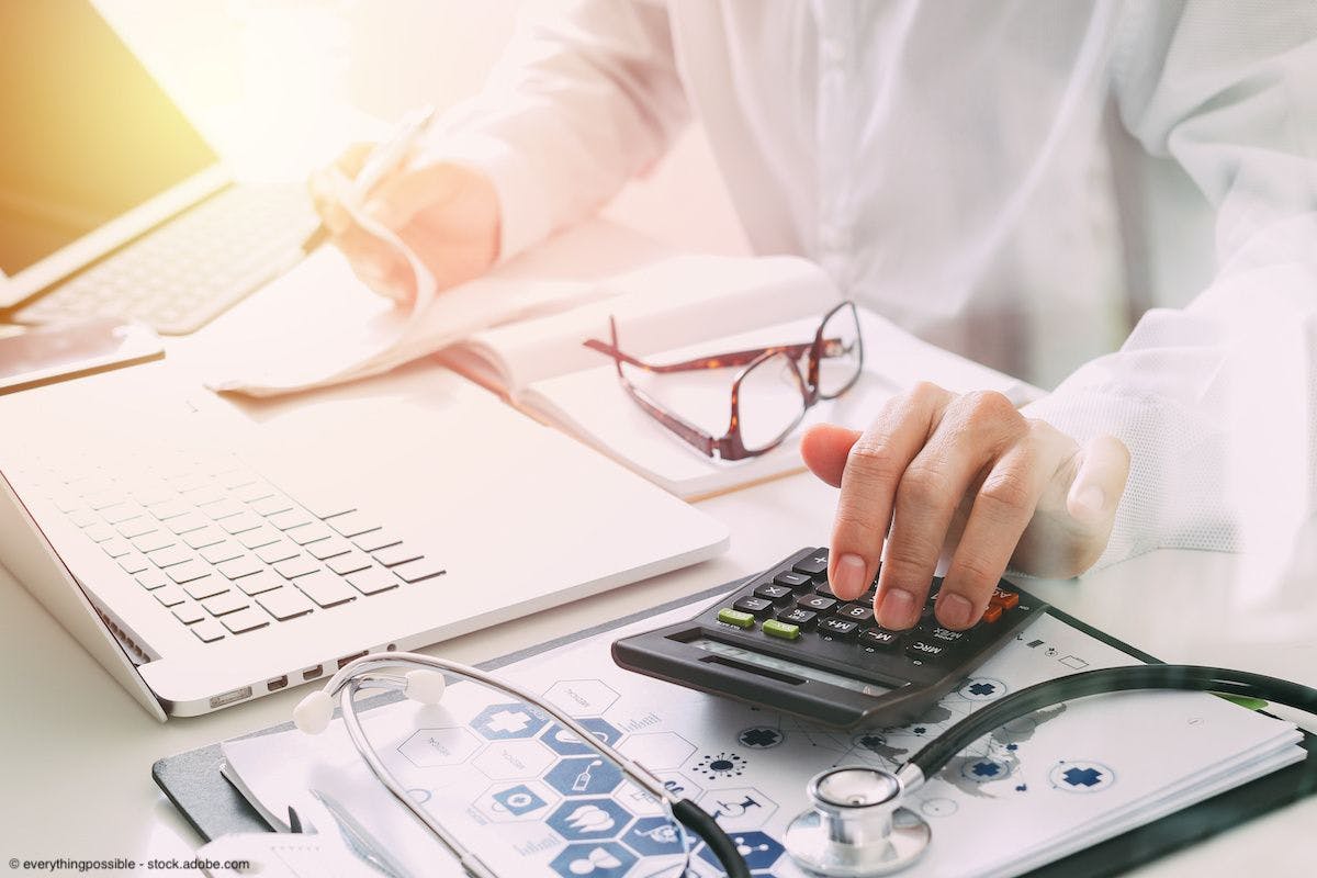 Doctor using calculator | Image Credit: © everythingpossible - stock.adobe.com