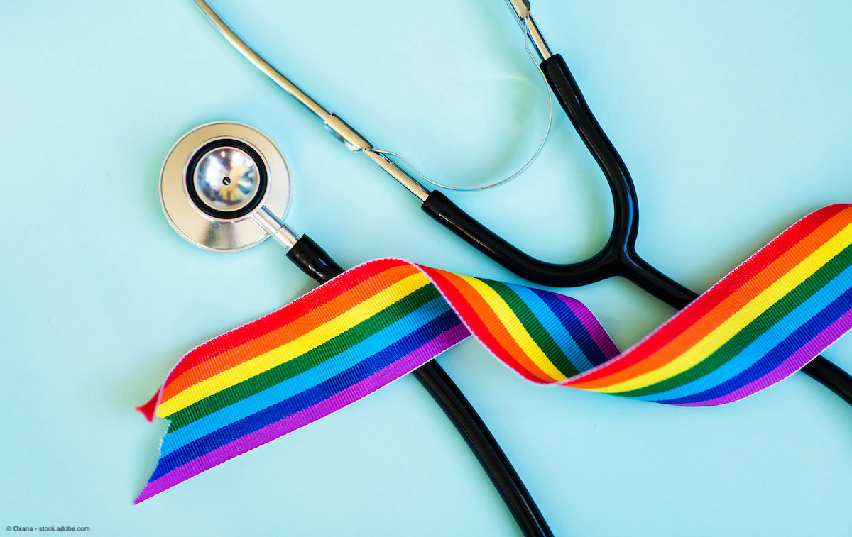 stethoscope and rainbow ribbon against a light blue background